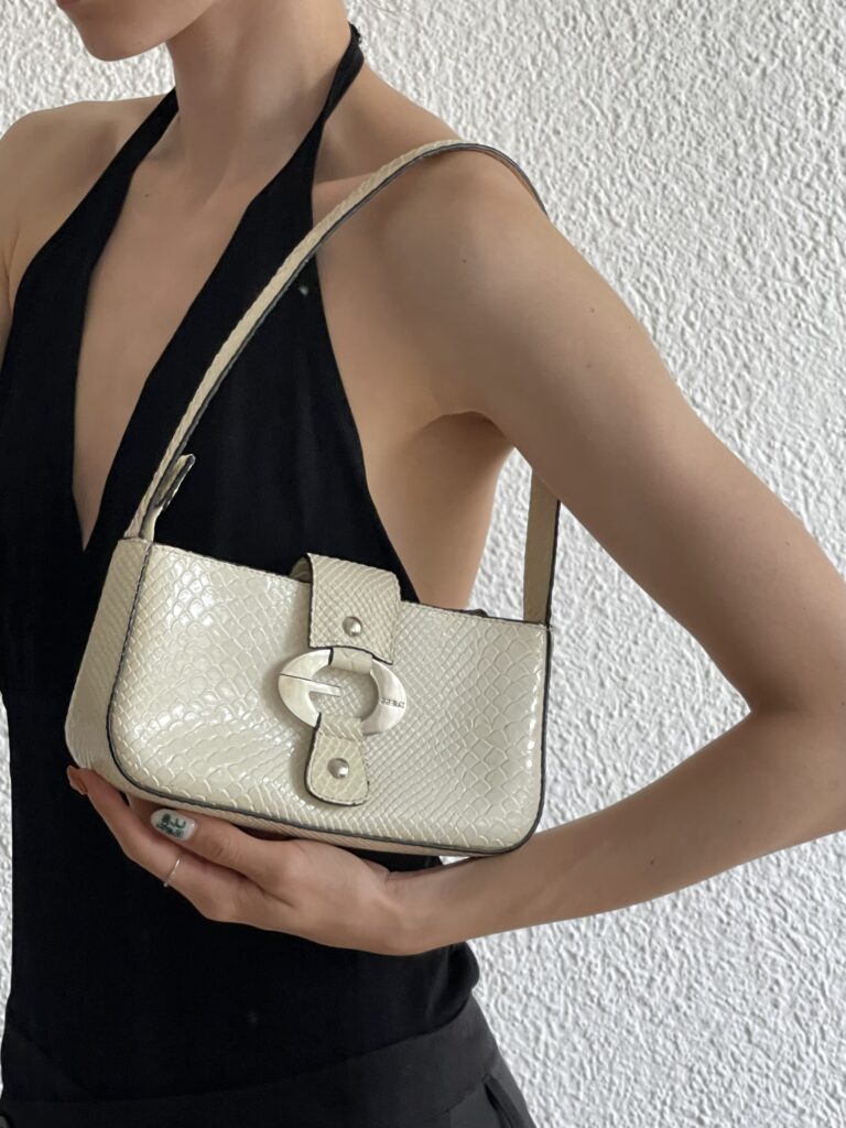 a girl wearing a coach bag